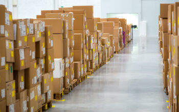 Large hangar warehouse of industrial and logistics companies long shelves with a variety of boxes